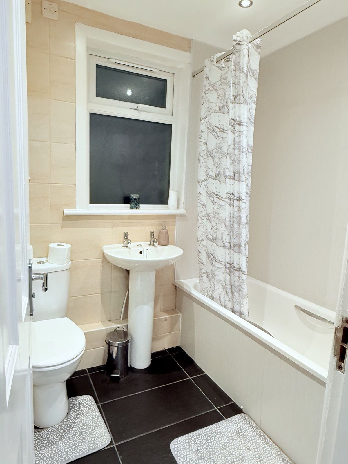 Family bathroom with bath, shower, toilet, and pedestal sink
