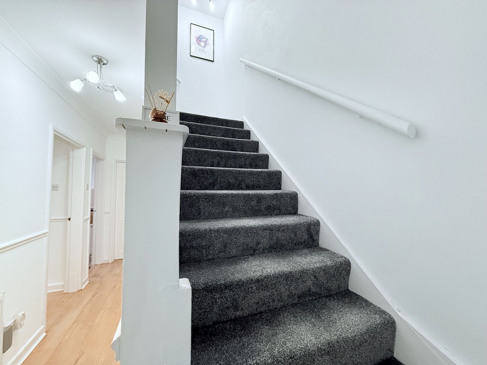 Entrance hall with carpeted staircase to the first floor